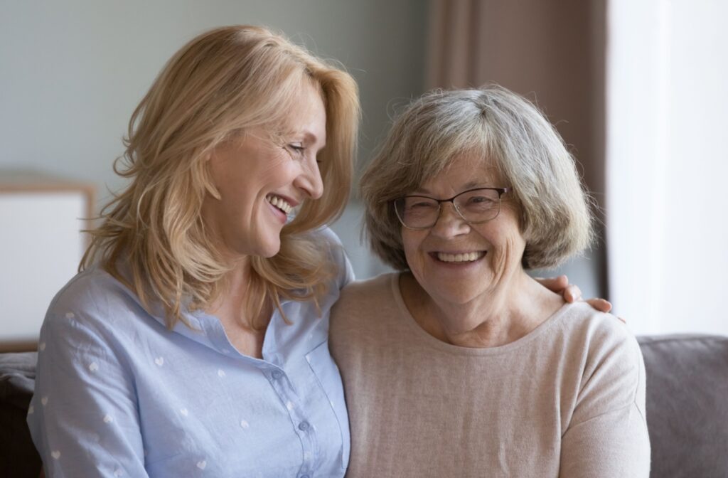 A happy senior and their adult child discuss future plans should dementia or cognitive decline become an issue.