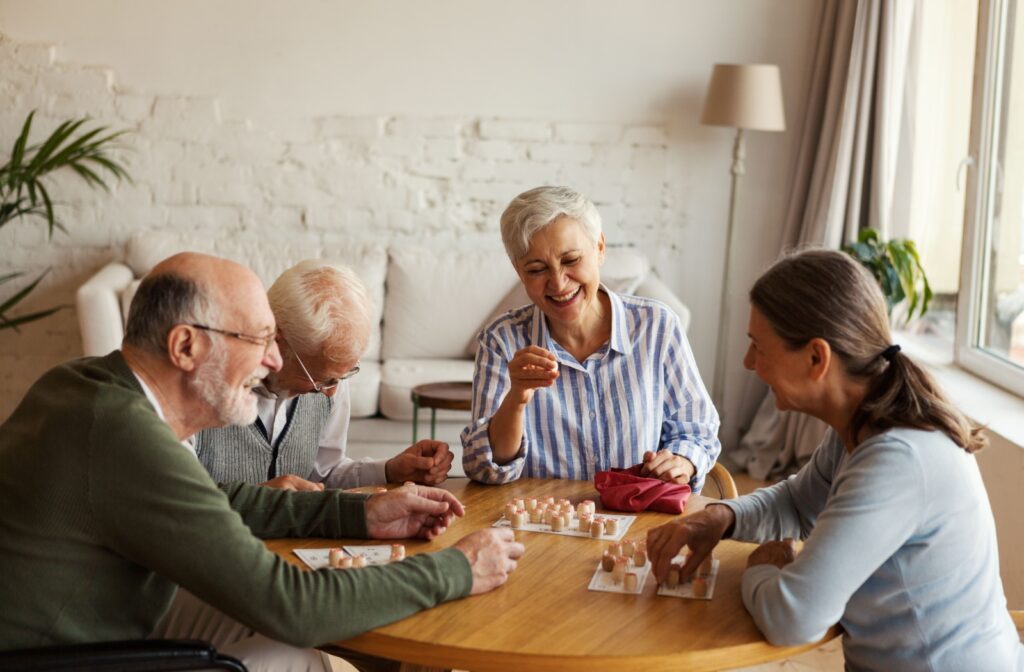 A group of seniors playing bingo on a sunlit room.