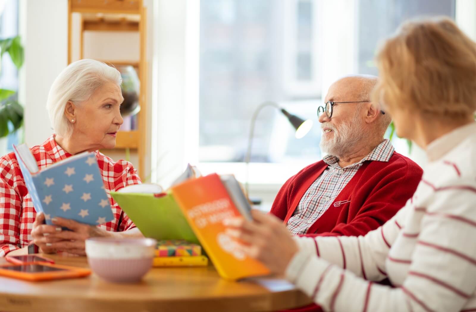 Seniors get together to discuss the latest book during their book club.